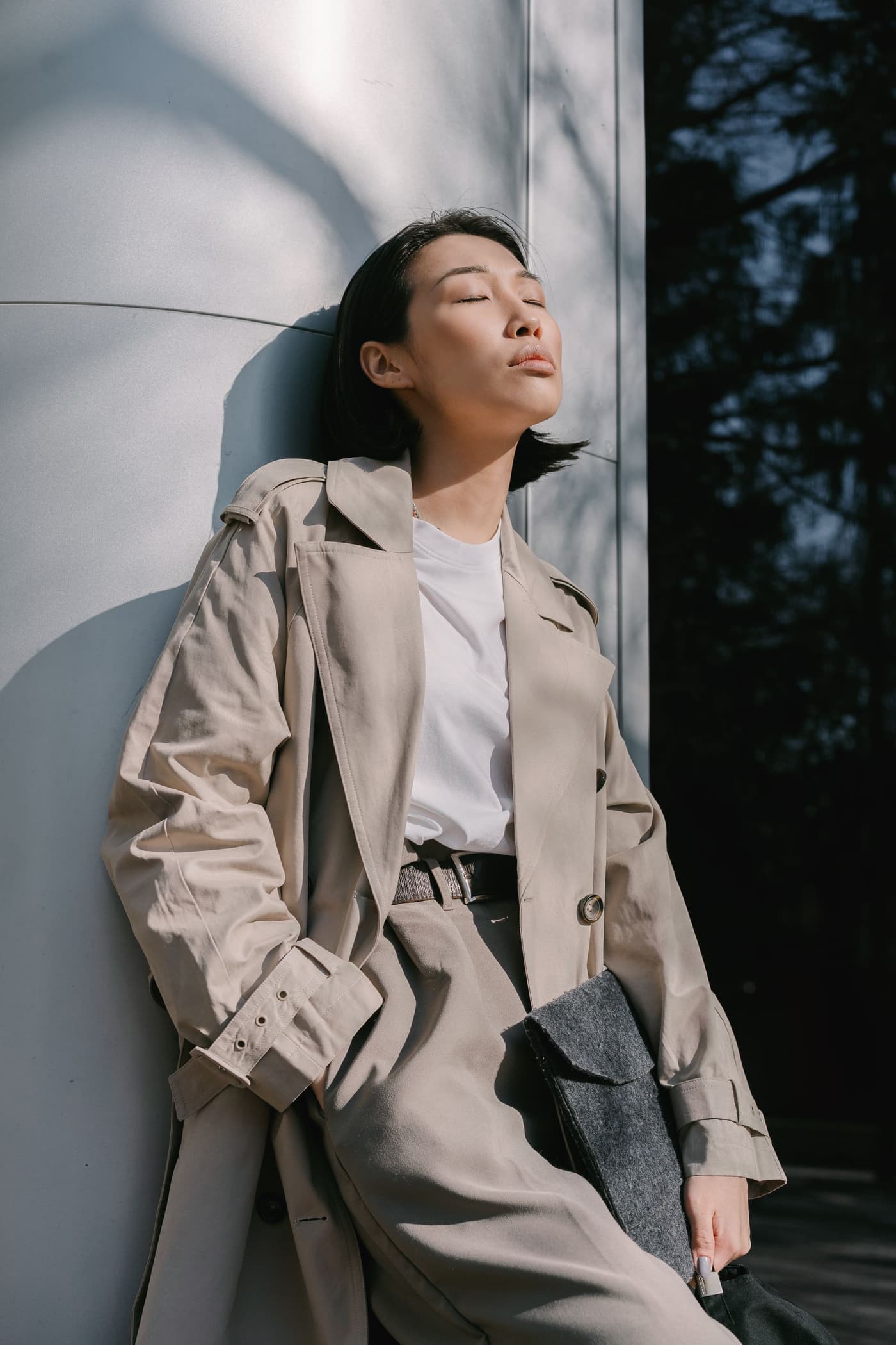 A woman in a camel coat, seen from behind.