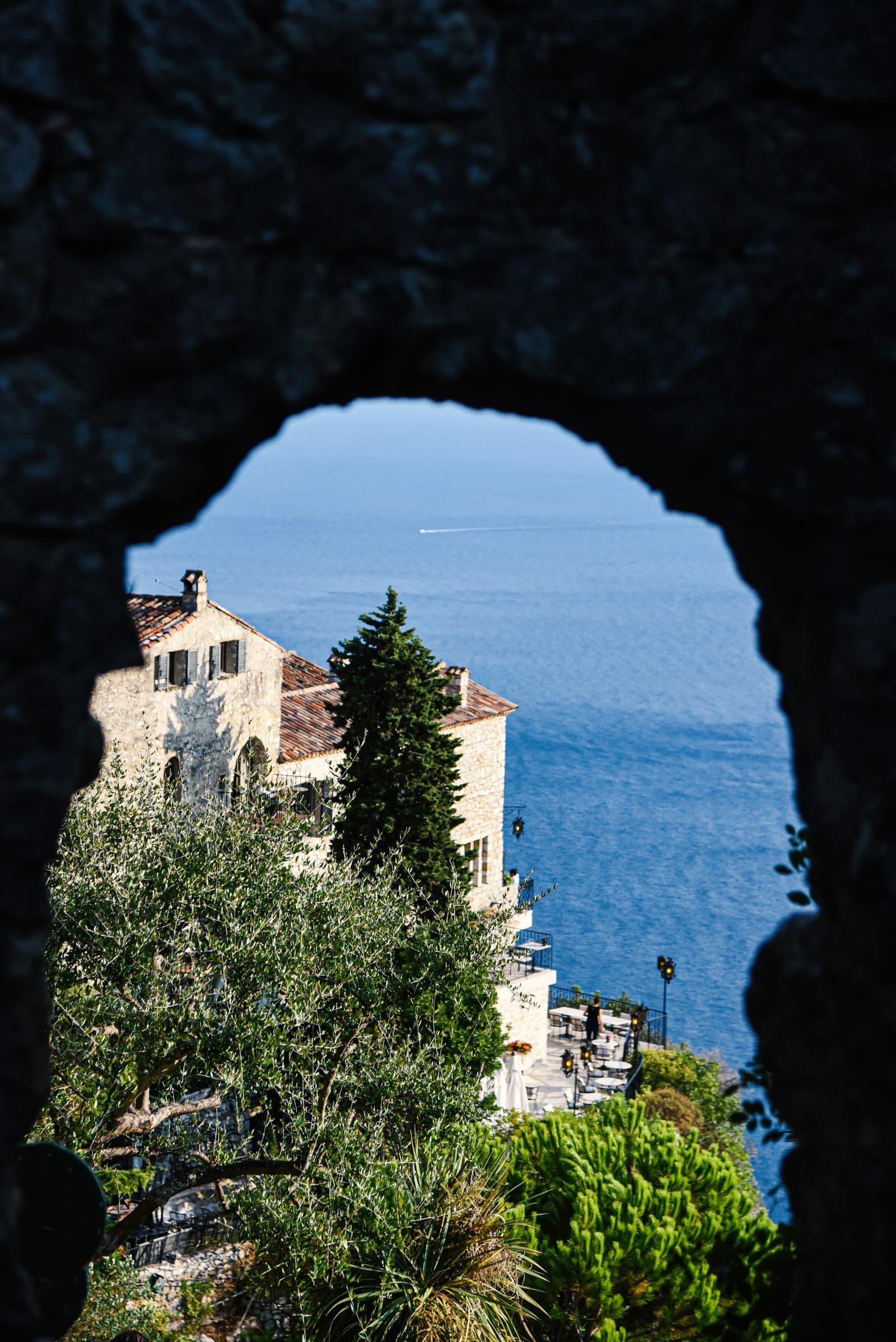 A stone terrace above a sunlit coast.